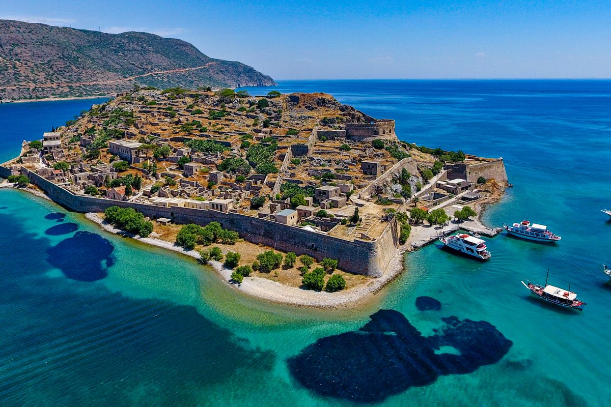 The Venetian fortress walls of Spinalonga island seen from the boat